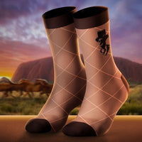 Pair of socks with a design against a scenic background